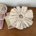 Detailed macro view of beige chiffon scrunchie with white polka dots and elegant texture - Off-white
