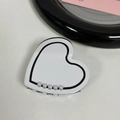 Detailed view of heart-shaped acetate hair claw clip with black edges and pearls - White