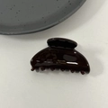 Detailed view of the glossy brown acetate hair claw with golden Barrette la France text - Chocolate Brown