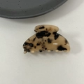 Macro detail of tortoiseshell acetate claw clip with golden lettering and glossy finish - Light Leopard