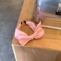 Elegant pink oversized bow headband with a satin-textured finish for women - Pink