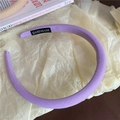 Padded purple fabric headband with handmade label on minimalist white paper background - Purple