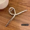 Macro shot of 13.5cm oversized silver metal hair claw clip with sleek polished finish - Silver