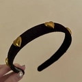 Detail of handmade black velvet headband with golden metal heart studs and inner label - Black