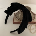 Elegant black velvet oversized bow headband placed on a vintage style desk background - Black