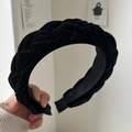 Detail of hand-held black velvet braided headband with thick texture and classic weave - Simple Woven Style