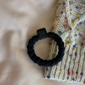 Black woven high elasticity hair tie with animal relief buckle on silk background - Black
