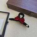 Elegant black velvet hair claw with a red velvet bow and a gold metallic logo tag - Red Large Hair Claw