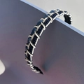 Detail of blue and white hand-woven headband with textured rope pattern on wood - Denim Blue Woven Style