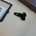 Close-up of black velvet bow hair clip with engraved golden metal believe charm - Black BB Clip