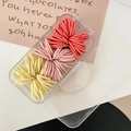 Macro detail of high-elasticity colorful hair ties set in a clear plastic storage box - Orange