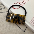 Classic tortoiseshell acetate hair tie with gold lettering on a minimalist background - Hair Tie / Dark Tortoiseshell