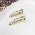 Juego de dos pinzas para el cabello de metal dorado ondulado con diseño minimalista - Dorado