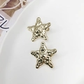 Par de pinzas para el cabello de estrella de mar dorada con acabado martillado - Dorado