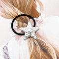 Detailed close-up of a high-elastic black hair tie featuring a silver starfish charm - Silver