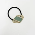 Detailed close-up of retro hair tie featuring gold metal frame and green enamel center - Pearl Rhombus Enamel Matcha Green Gold