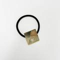 Detail of square gold-rimmed geometric charm with marble resin on elastic hair tie - Square Khaki Gold