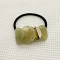 Detail of elastic hair tie with translucent green resin beads and golden metal accent - Matcha Green (540)
