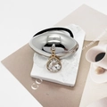 Detailed view of U-shaped hair tie with silver oval metal and teardrop crystal pendant - Model D Oval Mirror (556-D Silver)