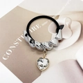 Detail of elastic hair tie with silver twisted metal and heart shaped crystal pendant - Twisted Silver Color