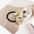 Detail of black hair tie with gold U-shaped metal clip and heart-shaped crystal pendant - Arc Golden (Style 555-A)