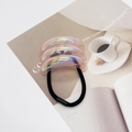 Detail of a U-shaped iridescent pink hair tie set on a magazine with soft lighting - Iridescent Rose Red