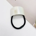 Macro shot of high-elastic black ponytail holder with a pearlescent U-shaped charm - Pearl White (8)