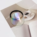 Detail of high-elasticity black hair tie with large iridescent acrylic round charm - Iridescent Blue-Green