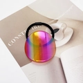 Detailed view of high-elasticity hair tie with iridescent circular gradient charm on magazine - Iridescent Orange-Red