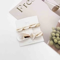 Close-up of summer seashell and starfish hair clips set on elegant display card - Pure White Natural Shell Style