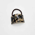 Macro detail of tortoiseshell pattern acrylic plate on elastic hair band accessory - Dark Leopard Print