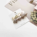 Detailed close-up of ocean-themed hair clips with natural shells on a display card - Multiple Shell and Leopard Conch Style