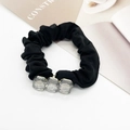 Close-up of black elastic hair tie with three sparkling square crystal embellishments - Transparent Rectangle Ornament
