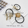 Lot de trois élastiques à cheveux noirs avec pendentifs dorés et perles d'imitation - Or (86-15)