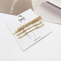 Dettaglio di tre fermagli per capelli color oro chiaro con strass color champagne - Trasparente