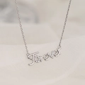 Silver Forever script necklace with micro-pave crystals on a white silk background - White Gold