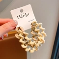 Elegant cream wavy elastic hair tie with texture and branded display tag - Yellow