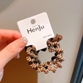 Brown and beige woven hair tie on paper display card for elegant ponytail styling - Brown
