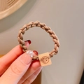 Coffee brown elastic braided hair tie with a square leather-like smiley face charm - Khaki