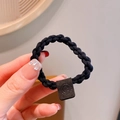 Elastic black braided hair tie featuring a square leather tag with a smiley face - Black