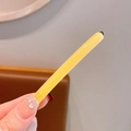 Elegant yellow resin long hair clip with gold finish and handmade text detail - Yellow