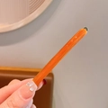 Elegant orange handmade hair clip in glossy resin finish for a French minimalist style - Caramel color
