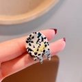 Small acetate hair claw clip with black and white spotted texture and gold logo - Black And White Spots