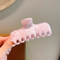 Pink marble pattern rectangular acrylic hair claw clip held by hand for style - Pink