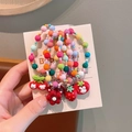 Gekleurde kralen haarelastiekjes voor kinderen met konijn en fruit bedeltjes op kaart - Bloemenarmband
