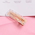 Detailed close-up of a gold metal hair clip featuring glittery acrylic inlay and a hollow design - Square-Silver
