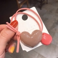 Pink elastic hair tie with brown heart and coral teardrop charms on a display card - Dusty Pink