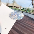 Handmade oval resin hair clip with blue shell fragments and glitter on a display card - Round Blue