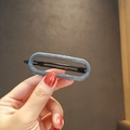 Elegant Morandi grey oval hollow hair clip held in hand for daily styling and hair grip - Gray