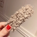 Hand holding a beige candy-colored faux shearling plush geometric hair clip for autumn - Gray